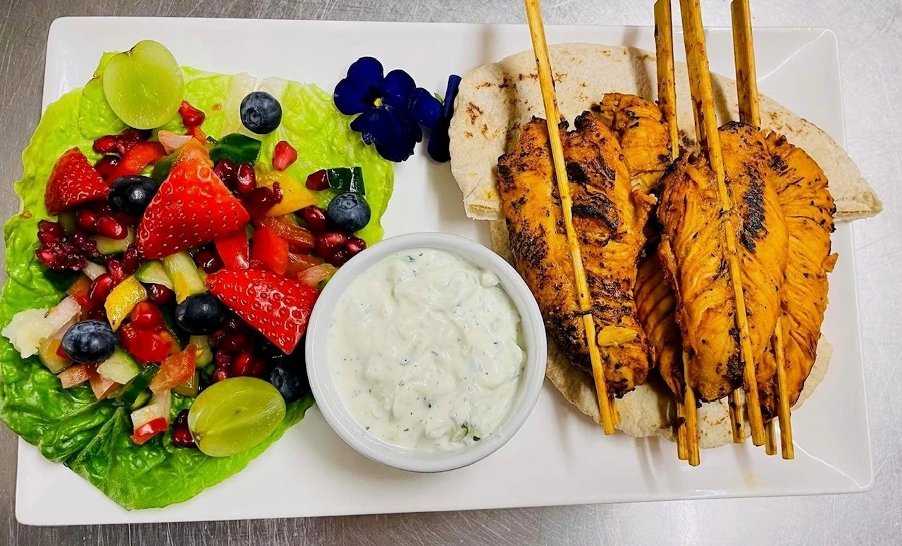Freshly prepared skewers, salad and tzatziki